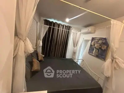 Cozy bedroom with elegant decor and air conditioning, featuring a stylish bed and modern curtains.