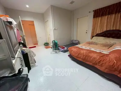 Spacious bedroom with cozy decor and ample natural light