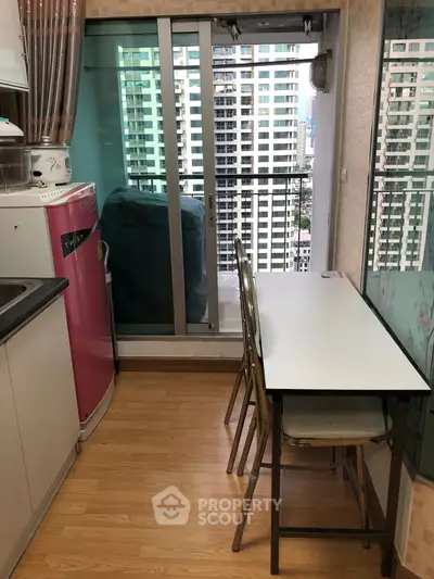Compact kitchen with balcony view in modern apartment