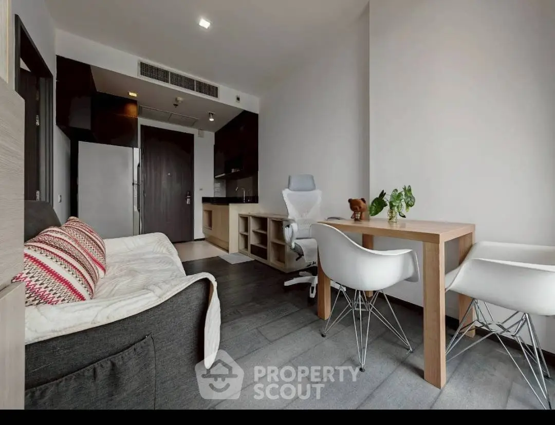 Modern living room with sleek furniture and open kitchen layout, perfect for urban living.