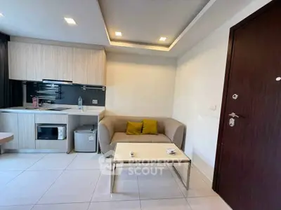 Modern compact living room with kitchenette and cozy seating area