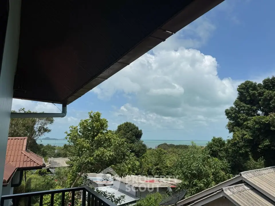 Stunning balcony view with lush greenery and ocean horizon, perfect for serene living.
