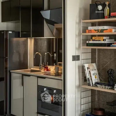 Modern kitchen with sleek appliances and stylish shelving in a contemporary apartment.