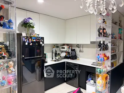Modern kitchen with sleek black and white design, featuring built-in appliances and decorative shelving.