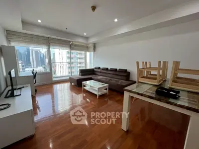 Spacious living room with city view and modern furnishings