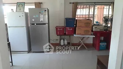 Spacious kitchen area with modern appliances and ample storage space.