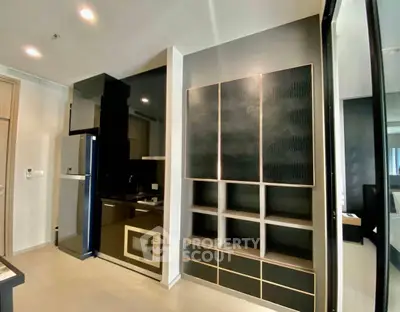 Modern kitchen with sleek black cabinetry and built-in appliances