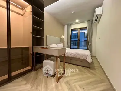 Modern bedroom with elegant design and spacious closet in a stylish apartment.