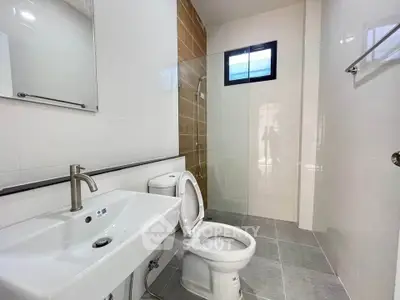 Modern bathroom with sleek fixtures and a spacious shower area.