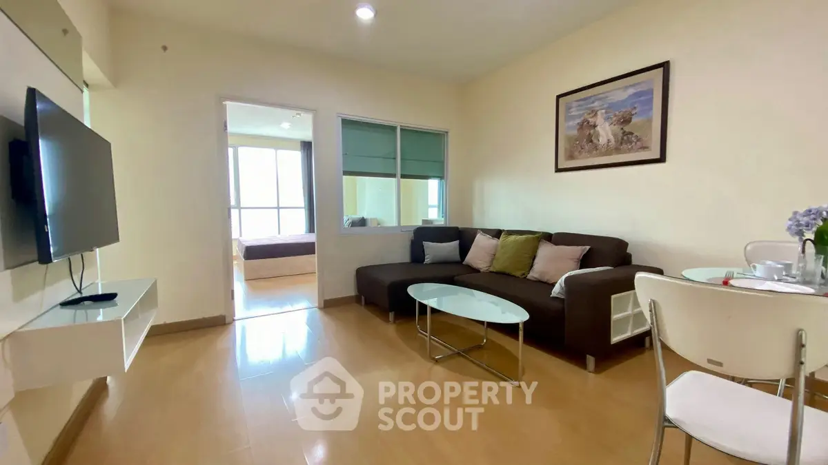 Cozy living room with modern decor and natural light, perfect for relaxation.
