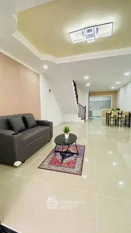 Spacious modern living room with elegant decor and open dining area