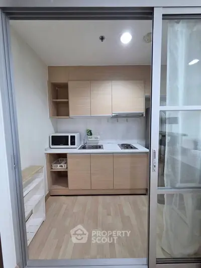 Modern compact kitchen with sleek cabinetry and appliances