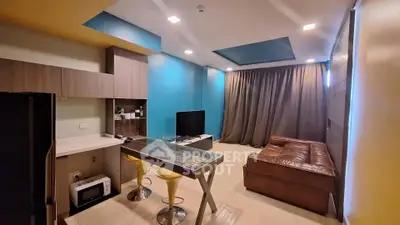 Modern living room with stylish furniture and vibrant blue accent wall