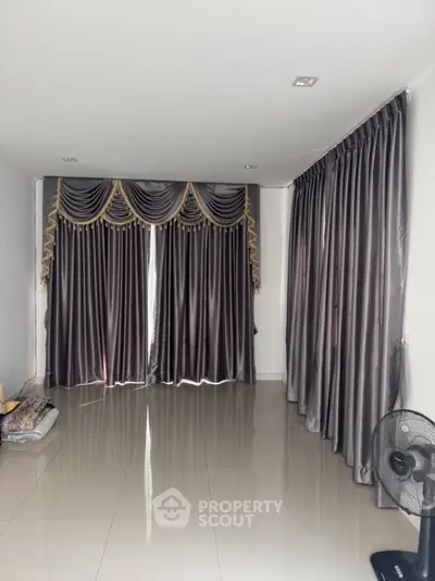 Spacious room with elegant curtains and glossy tiled floor