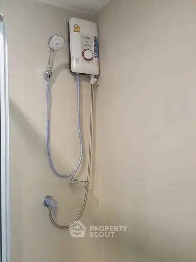 Modern bathroom with wall-mounted shower heater and sleek design.