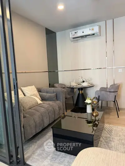 Modern living room with sleek furniture and air conditioning, perfect for comfort and style.