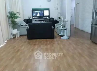 Spacious living room with modern decor and wooden flooring