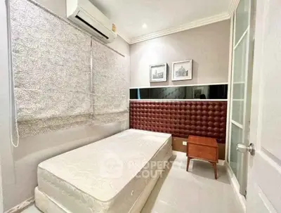 Cozy bedroom with modern decor, featuring a comfortable bed and stylish wall art.