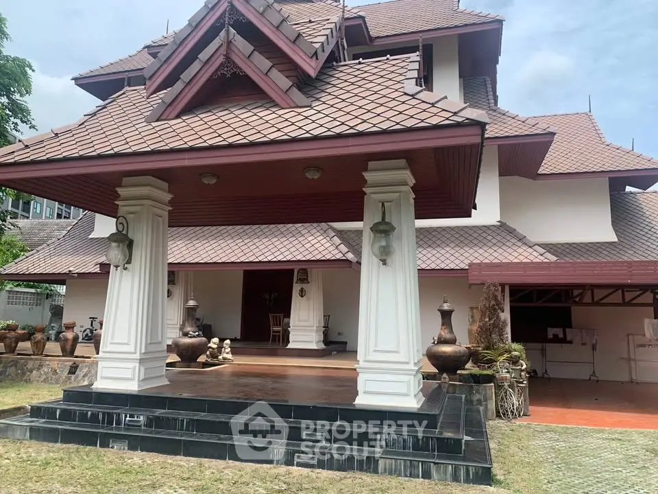 Stunning traditional-style house with unique architectural roof and spacious entrance.