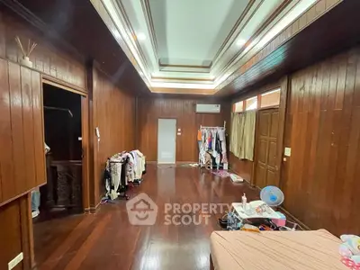 Spacious wooden interior bedroom with high ceiling and ample natural light