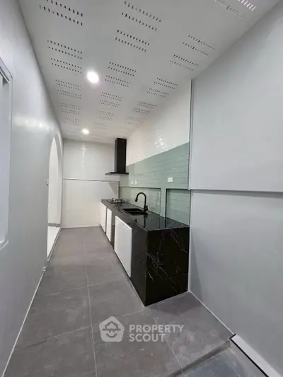 Modern kitchen with sleek black countertops and minimalist design