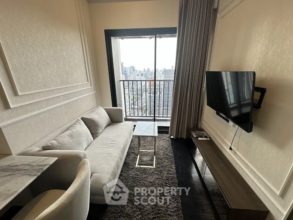 Modern living room with city view, featuring sleek furniture and large window for natural light.