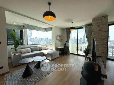 Modern living room with city view, stylish furniture, and natural light