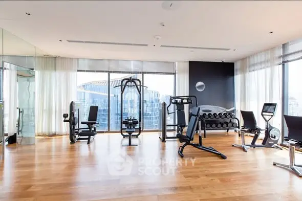 Luxurious high-rise gym with modern equipment and stunning city views.