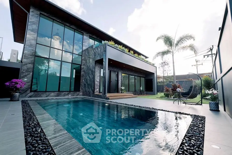 Luxurious modern home with private pool and lush garden, perfect for relaxation and entertainment.