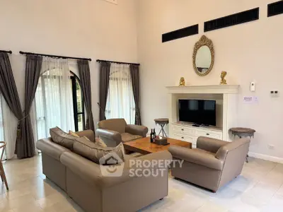 Luxurious living room with elegant decor and high ceilings, perfect for relaxation and entertainment.
