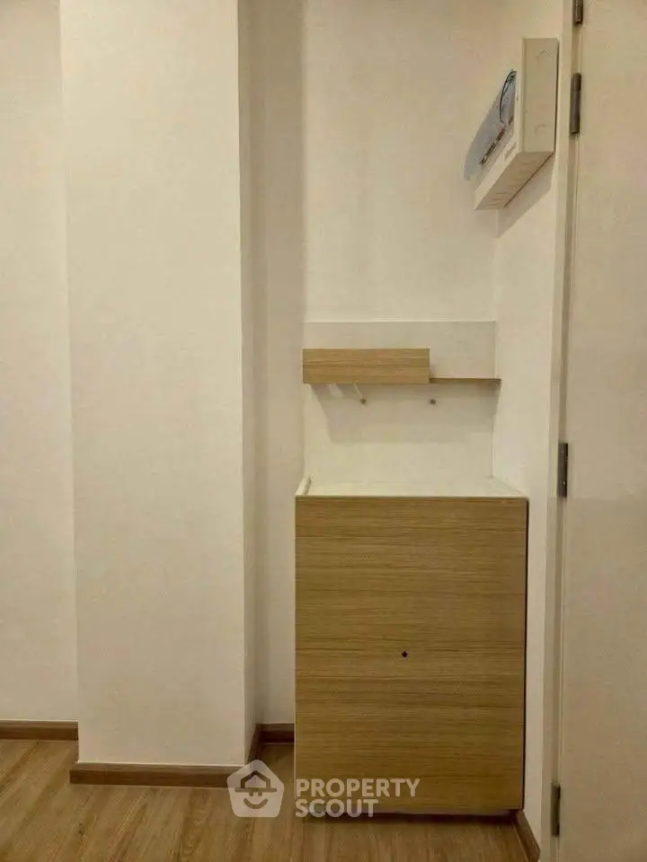 Minimalist interior corner with wooden cabinet and white walls, perfect for modern home design.