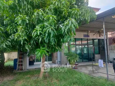 Charming residential property with lush garden and modern glass facade