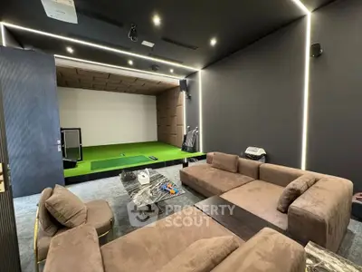 Luxurious home theater with plush seating and indoor golf simulator