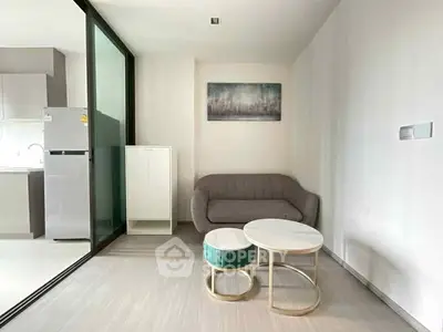 Modern minimalist living room with cozy sofa and stylish coffee tables.