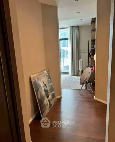 Stylish hallway leading to a modern living area with floor-to-ceiling windows.