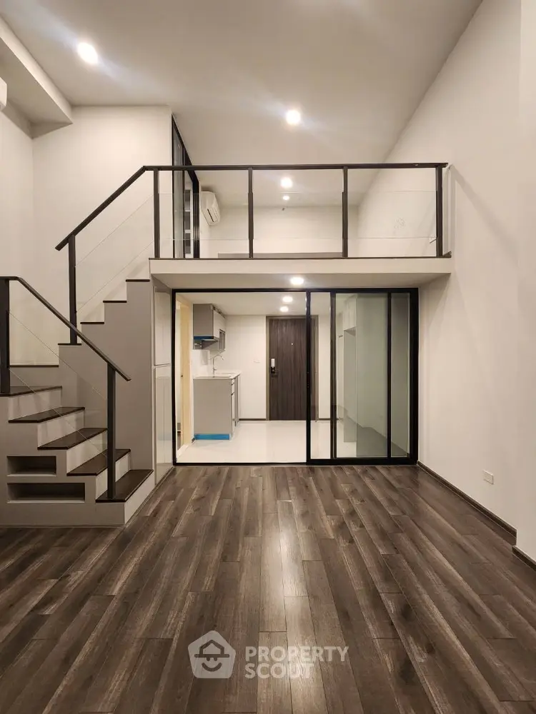 Modern loft apartment with mezzanine and sleek wooden flooring