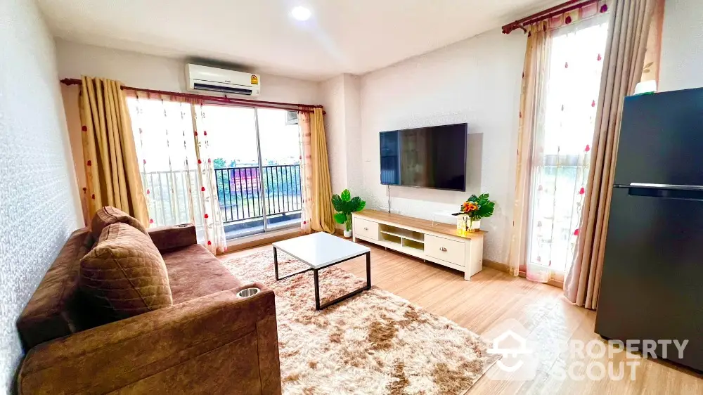 Spacious living room with modern decor and balcony access