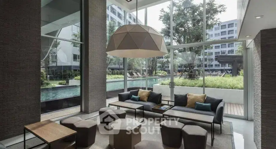 Luxurious modern living room with pool view and stylish furniture in a high-end apartment complex.
