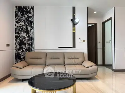 Modern living room with stylish sofa and marble coffee table