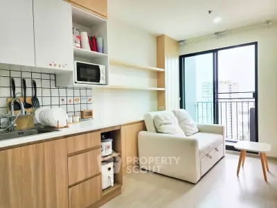 Modern living room with kitchenette and balcony view in urban apartment