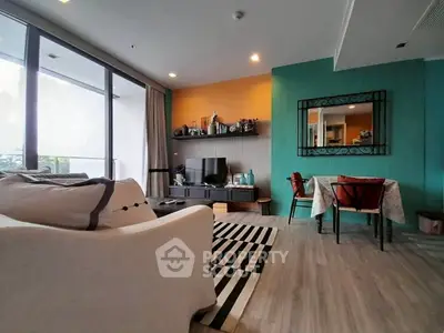 Stylish living room with modern decor and vibrant accent wall, perfect for relaxation and entertainment.
