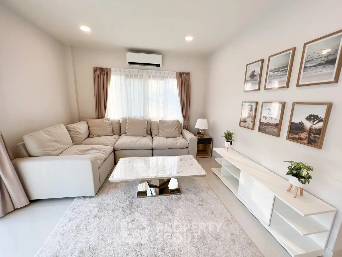 Elegant living room with cozy sectional sofa, marble coffee table, and stylish decor in a bright, airy space.