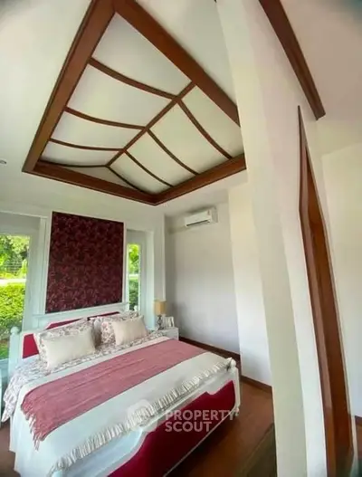 Luxurious bedroom with elegant ceiling design and garden view, featuring a cozy bed and stylish decor.