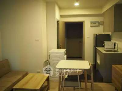 Cozy apartment interior with modern kitchen and living area, featuring a washing machine and stylish furniture.