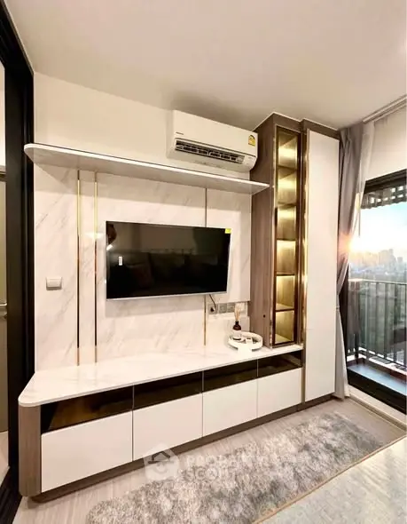 Modern living room with stylish TV unit and balcony view