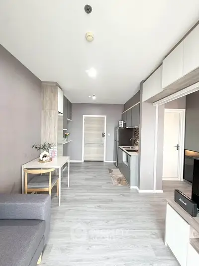 Modern open-plan living room with sleek kitchen and stylish decor