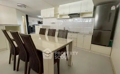 Spacious kitchen with dining area, featuring modern appliances and ample storage.