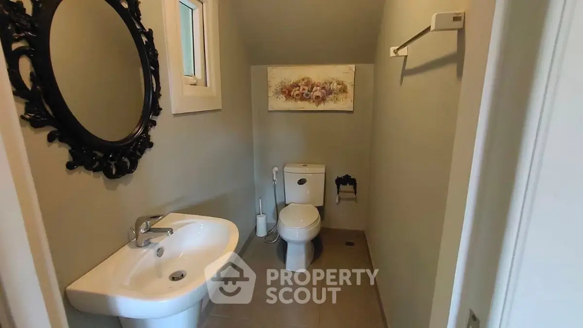 Cozy bathroom with elegant mirror and modern fixtures.