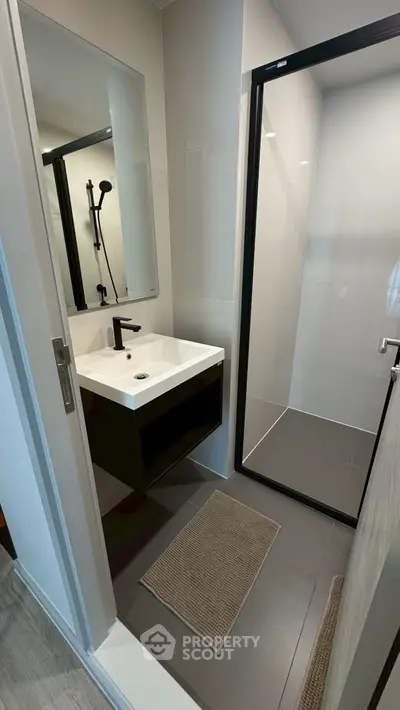 Modern bathroom with sleek design featuring a glass shower and stylish vanity.
