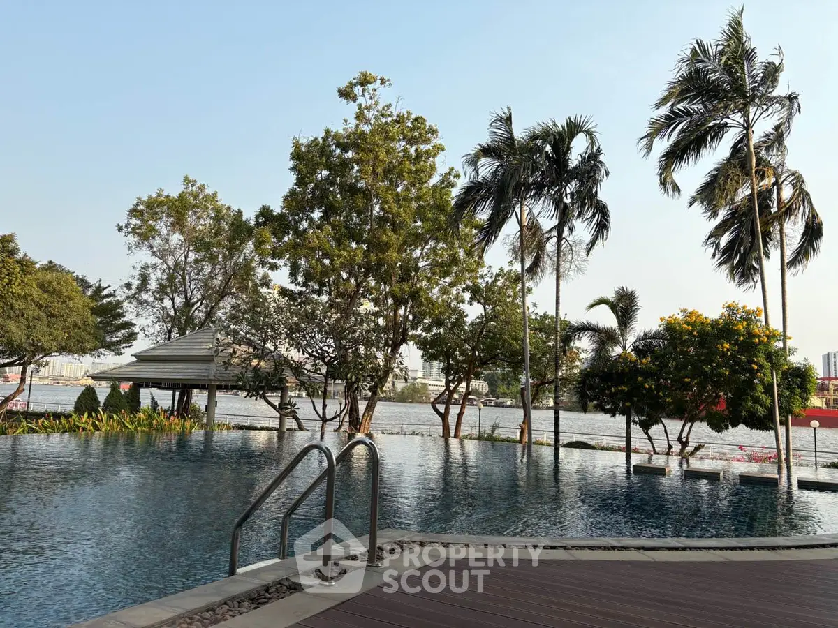 Luxurious riverside pool with lush greenery and serene ambiance